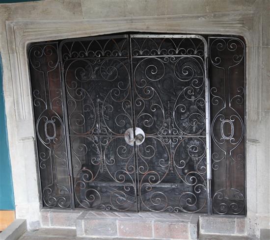 A heavy wrought iron chimneypiece spark guard, approx. W.3ft 7in.